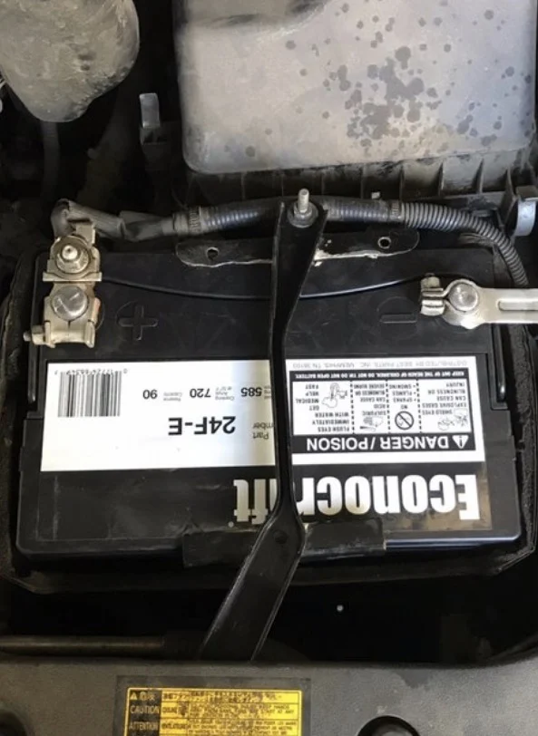 Automotive replacement battery installed under the hood