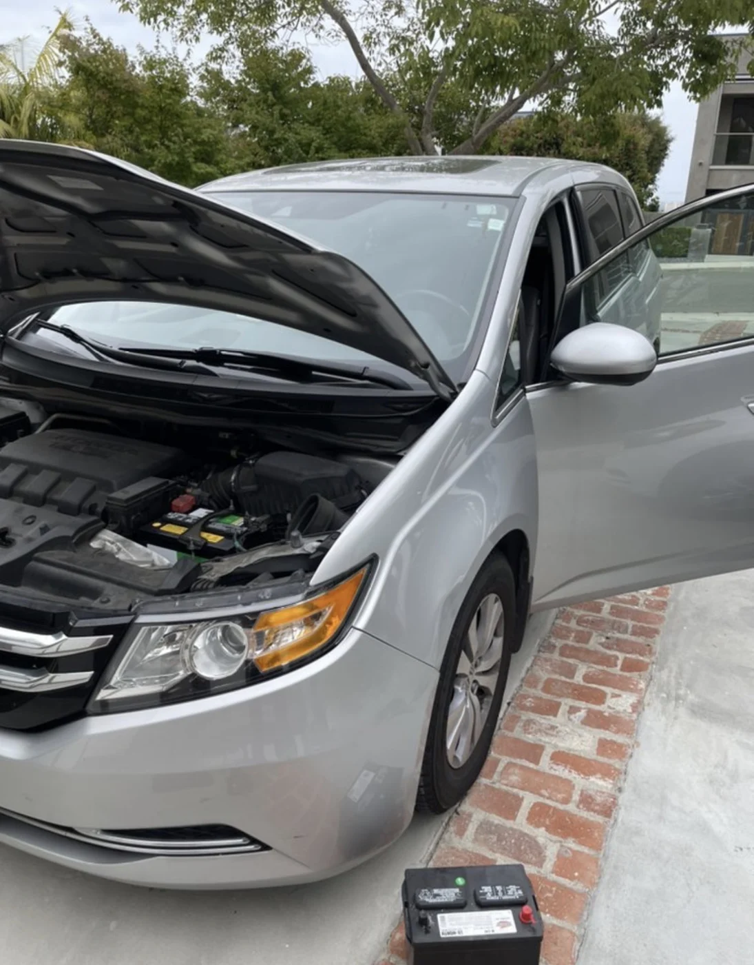 Automotive battery service at a parked car